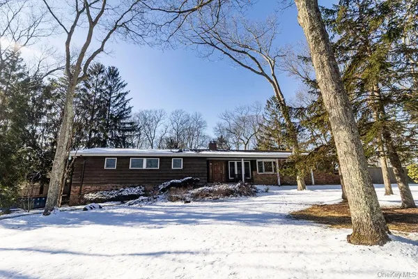 a view of a house with snow on the road
