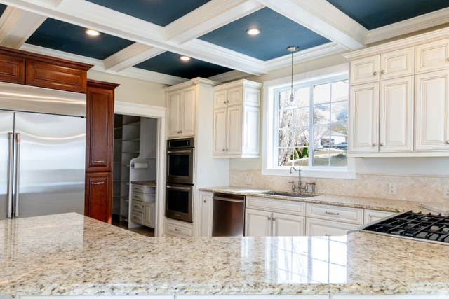 434 Cardon Ridge Drive Smithfield, UT 84335 - Photo 10 of 59 Kitchen featuring stainless steel appliances, light stone countertops, crown molding, pendant lighting, and coffered ceiling