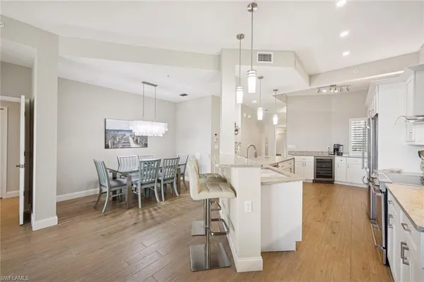 a view of a dining room with furniture wooden floor and chandelier