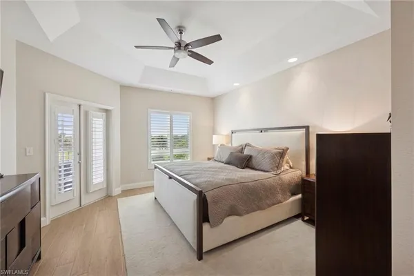 a bedroom with a bed and painting on the wall