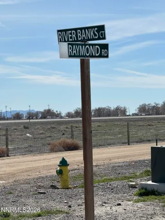 a street sign on a pier next to a lake