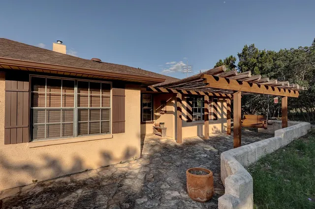 a view of a house with backyard and sitting area
