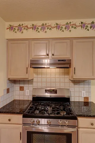 a close view of a stove a microwave and cabinets in the kitchen