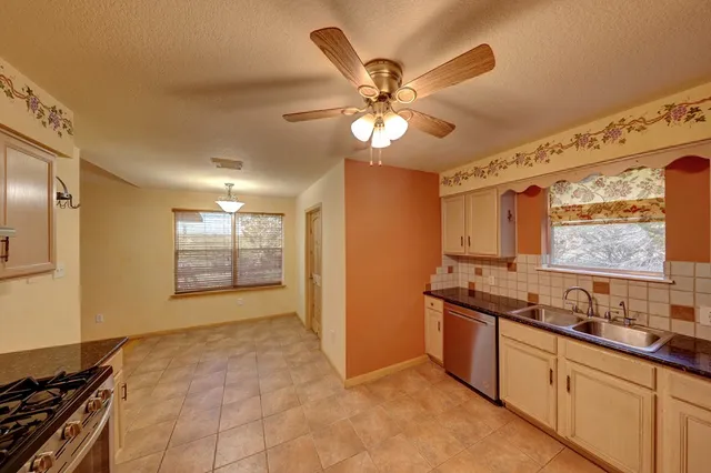 a view of a kitchen with a sink and a window