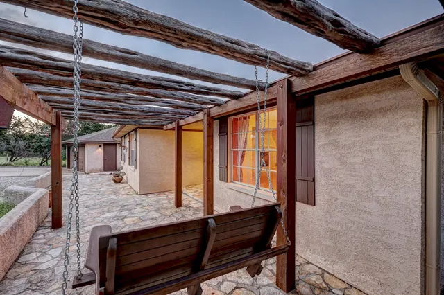 a roof deck with wooden floor and outdoor seating