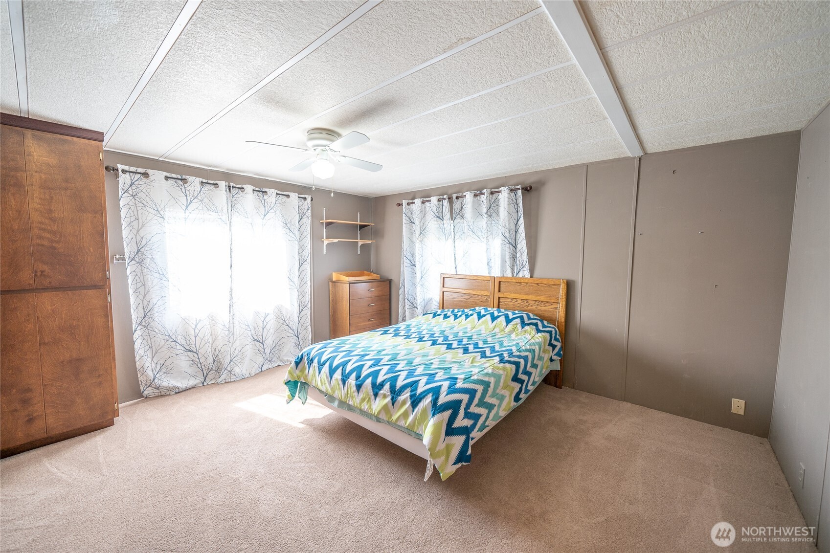 57 Clemons Road, Unit 68 Montesano, WA 98563 - Photo 14 of 27 a room with a bed chandelier and a window