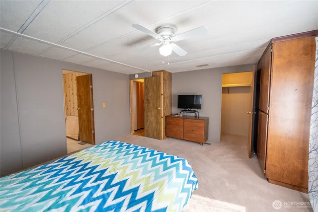 a bedroom with a bed and a television