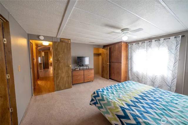 a bedroom with a bed and a large mirror