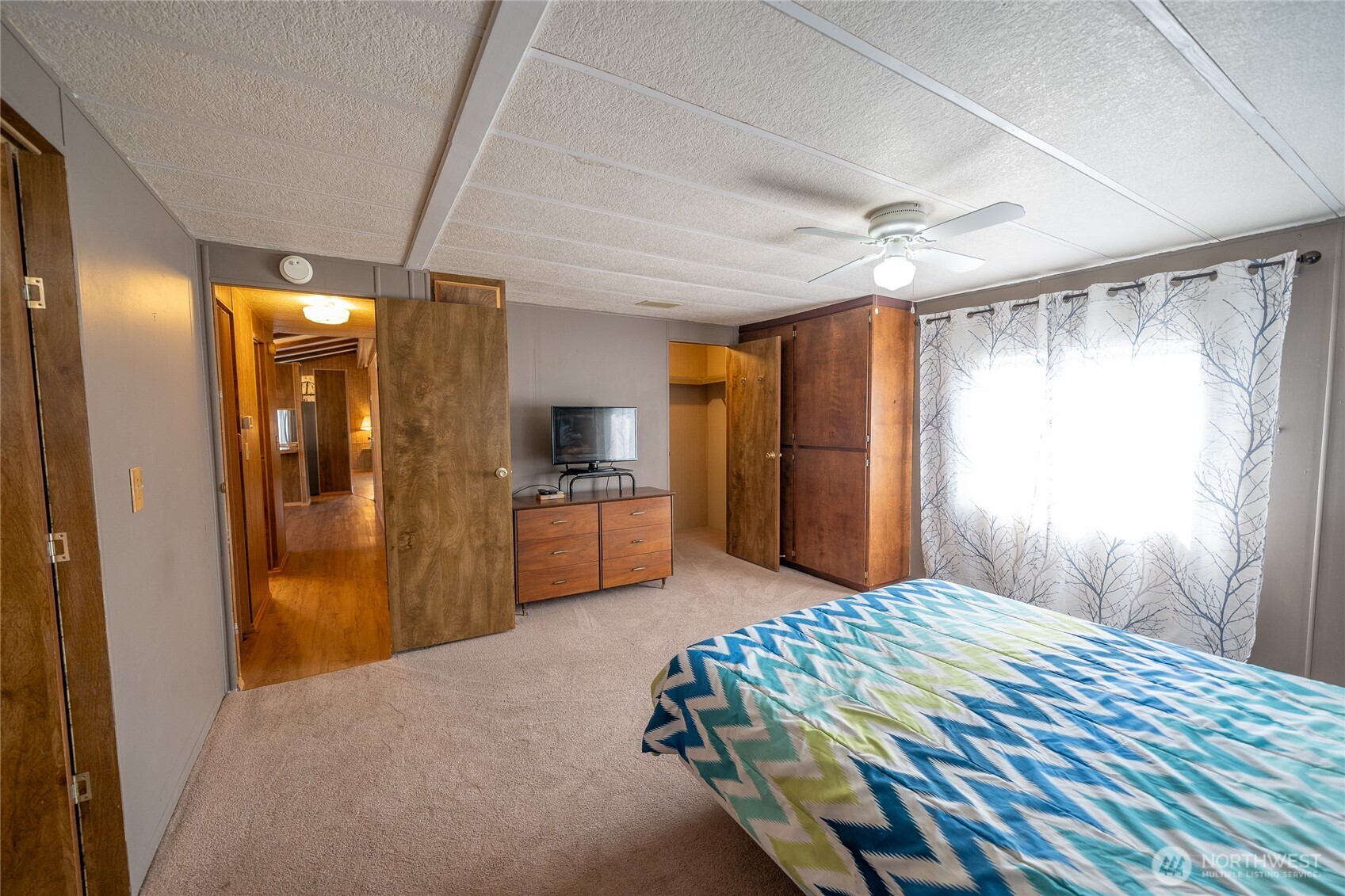 57 Clemons Road, Unit 68 Montesano, WA 98563 - Photo 17 of 27 a bedroom with a bed and a large mirror
