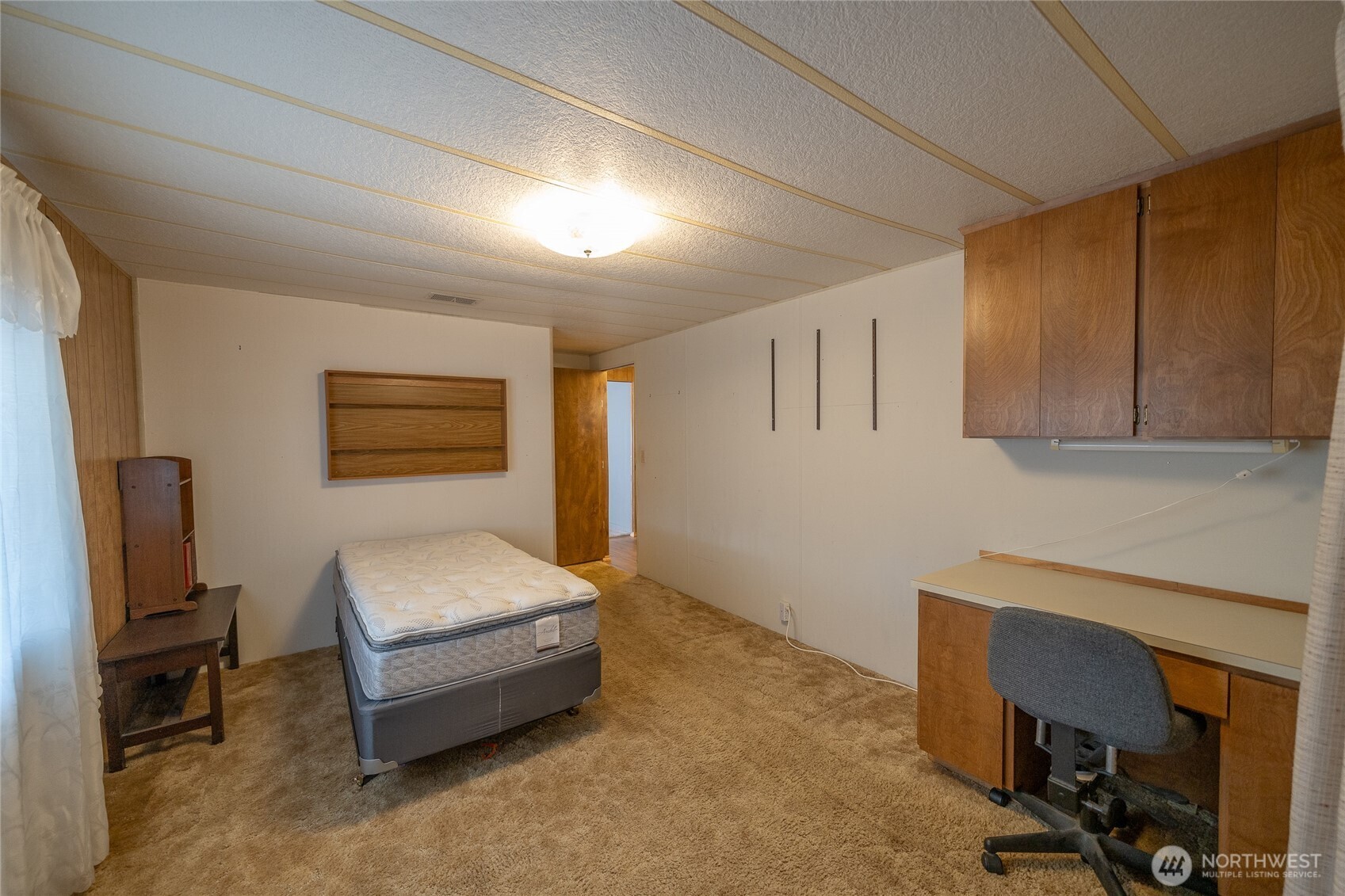 57 Clemons Road, Unit 68 Montesano, WA 98563 - Photo 21 of 27 a spacious bedroom with a bed and a desk
