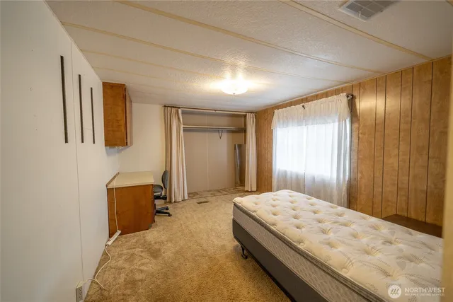 a bedroom with a bed and mirror