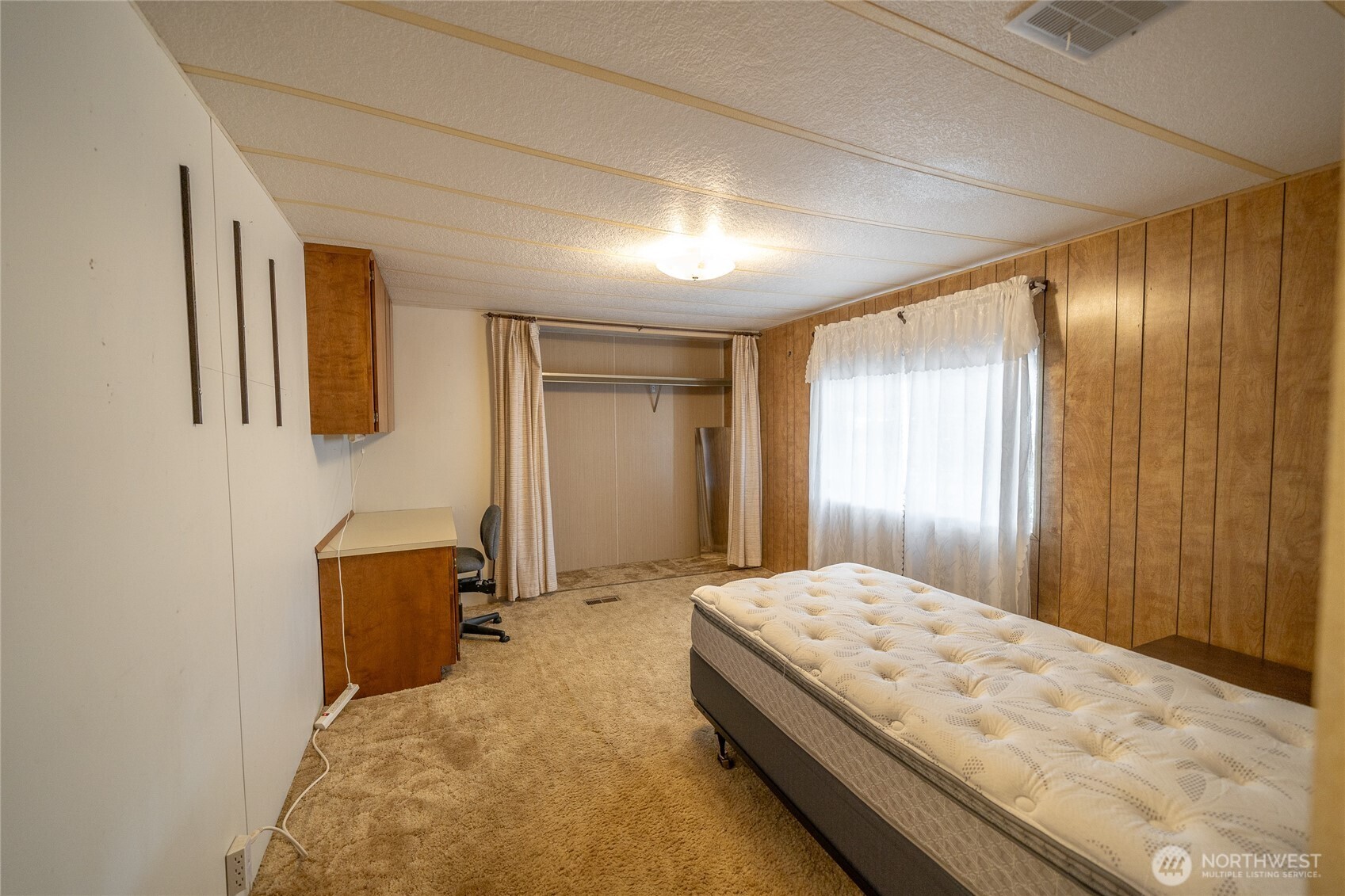 57 Clemons Road, Unit 68 Montesano, WA 98563 - Photo 22 of 27 a bedroom with a bed and mirror