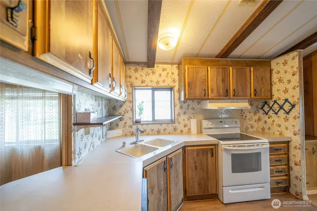 a kitchen with a stove and a sink