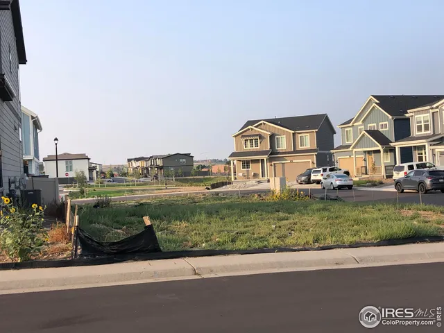 a view of a street with a car parked on the road