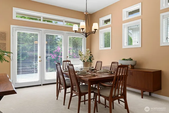 a view of a dining room with furniture and windows