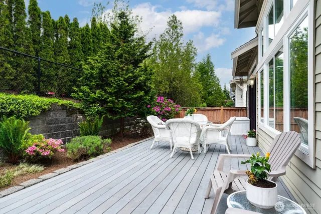 a view of a patio with table and chairs and potted plants