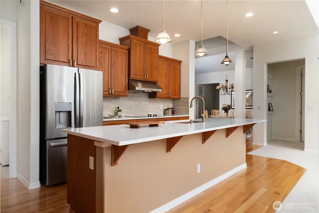 a kitchen with stainless steel appliances a sink stove and refrigerator