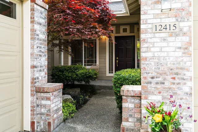 a front view of a house with a garden