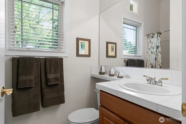 a bathroom with a sink toilet and a mirror