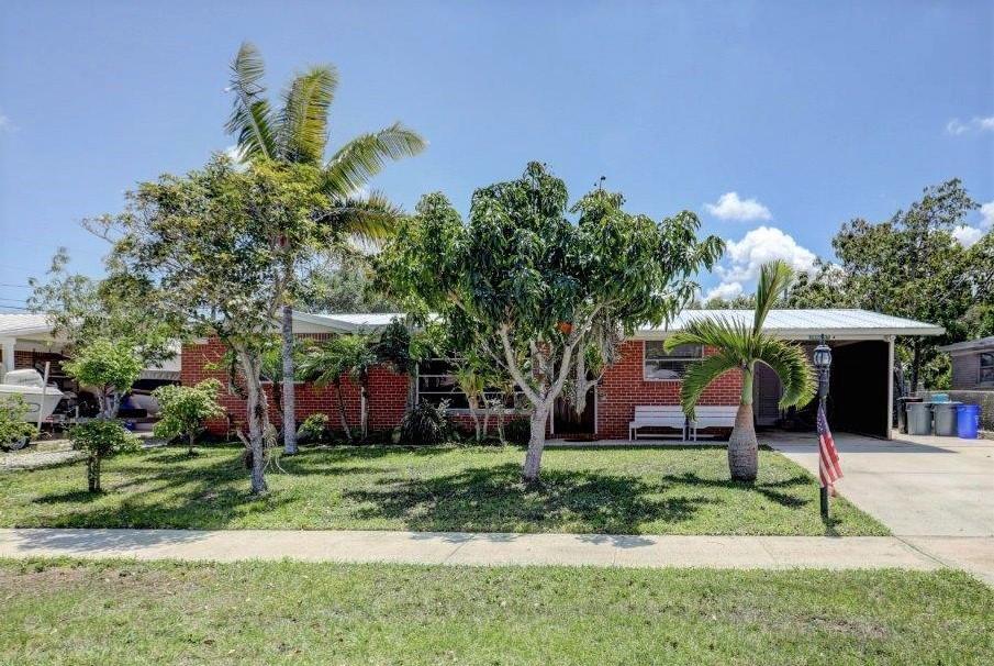 5806 Keith Road Jupiter, FL 33458 - Photo 1 of 24 front view of a house with a yard