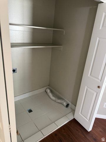 1563 South 600 East Springville, UT 84663 - Photo 17 of 30 Utility closet with tiled flooring, two built-in shelves, electrical outlet, and a bi-fold door