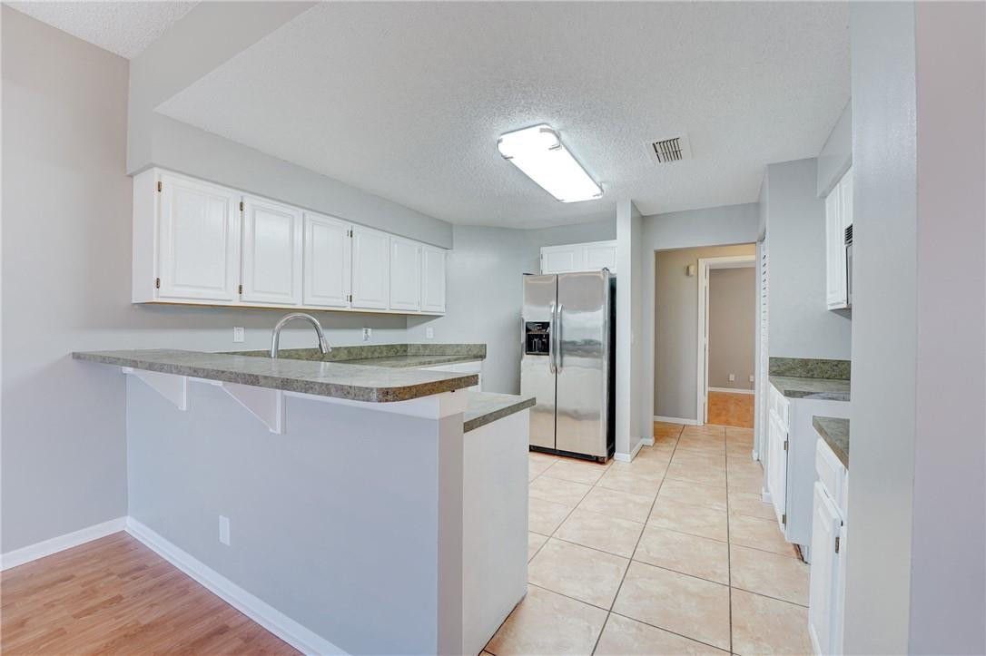 Undisclosed Address Davie, FL 33328 - Photo 13 of 24 a kitchen with kitchen island granite countertop a refrigerator and a sink