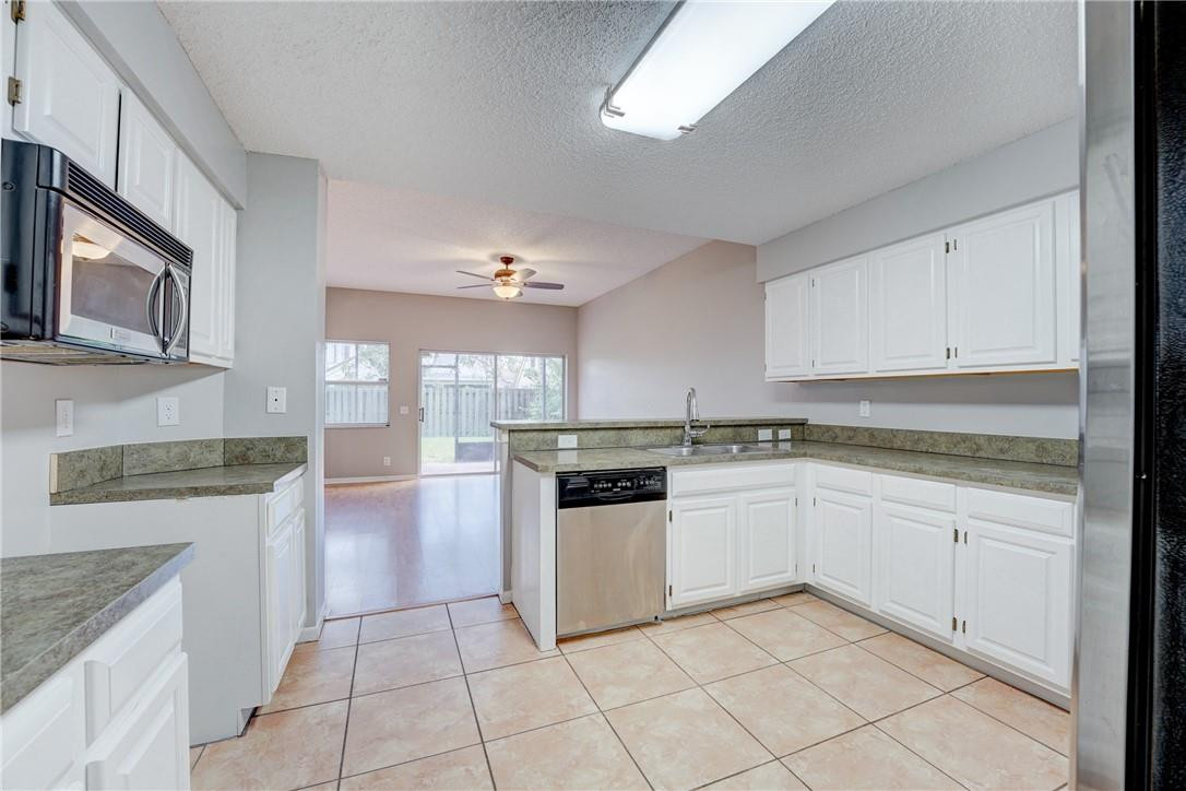 Undisclosed Address Davie, FL 33328 - Photo 14 of 24 a kitchen with a stove top oven sink and cabinets