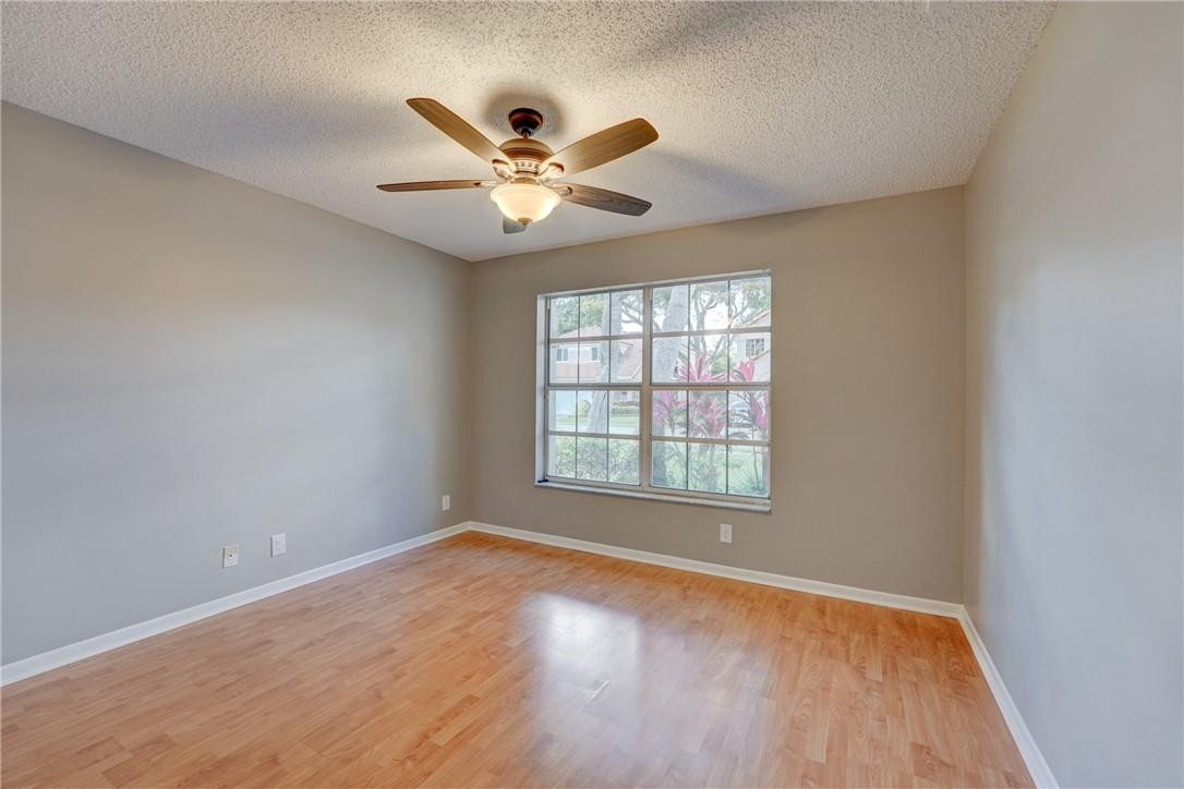 Undisclosed Address Davie, FL 33328 - Photo 17 of 24 an empty room with wooden floor fan and windows
