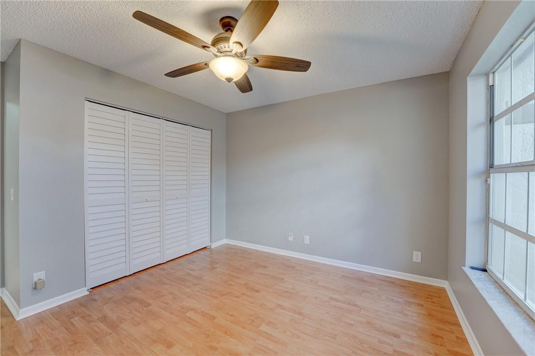 Undisclosed Address Davie, FL 33328 - Photo 18 of 24 an empty room with wooden floor and windows