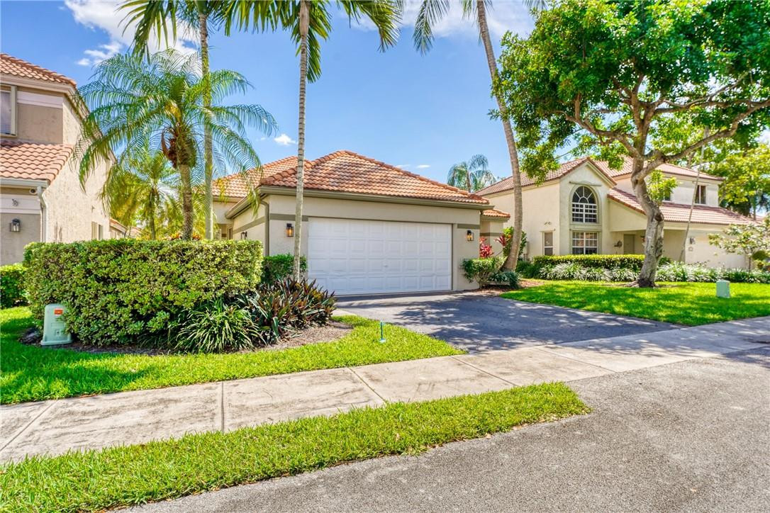 Undisclosed Address Davie, FL 33328 - Photo 2 of 24 a front view of a house with a garden and yard