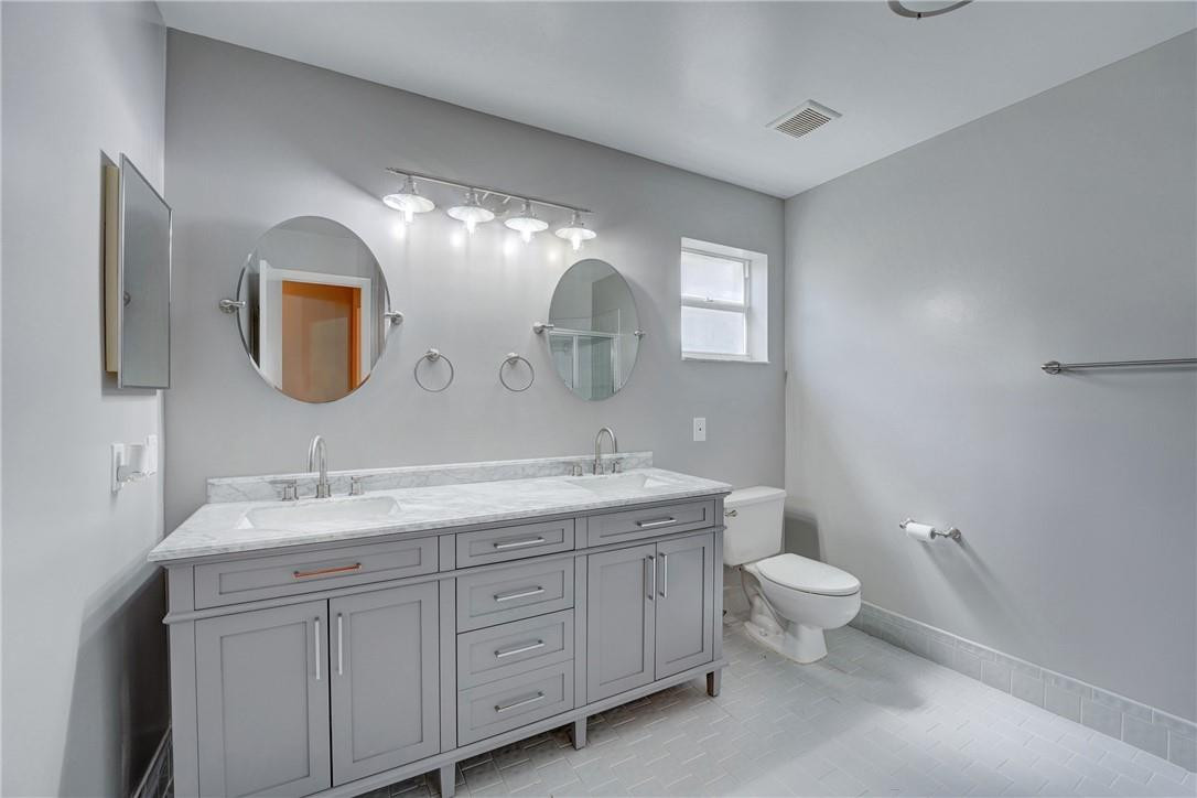 Undisclosed Address Davie, FL 33328 - Photo 23 of 24 a bathroom with a double vanity sink and a mirror