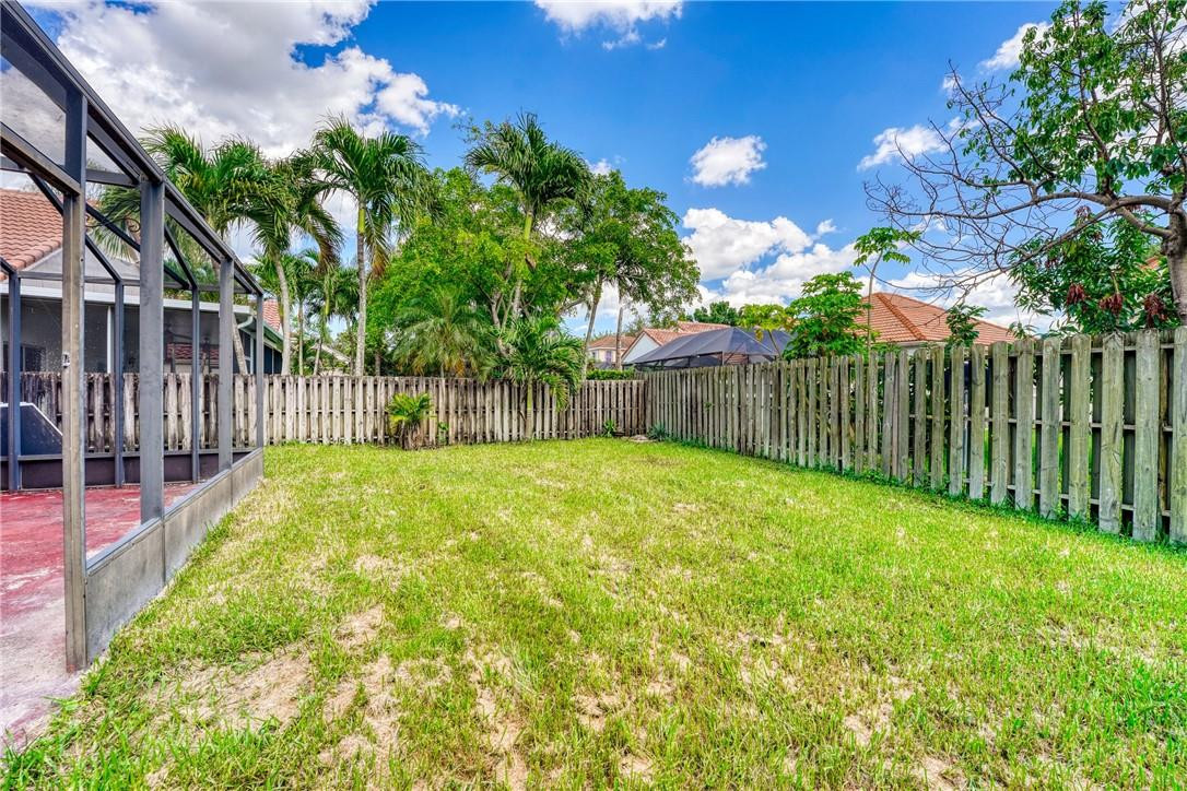 Undisclosed Address Davie, FL 33328 - Photo 6 of 24 a view of a backyard with a garden
