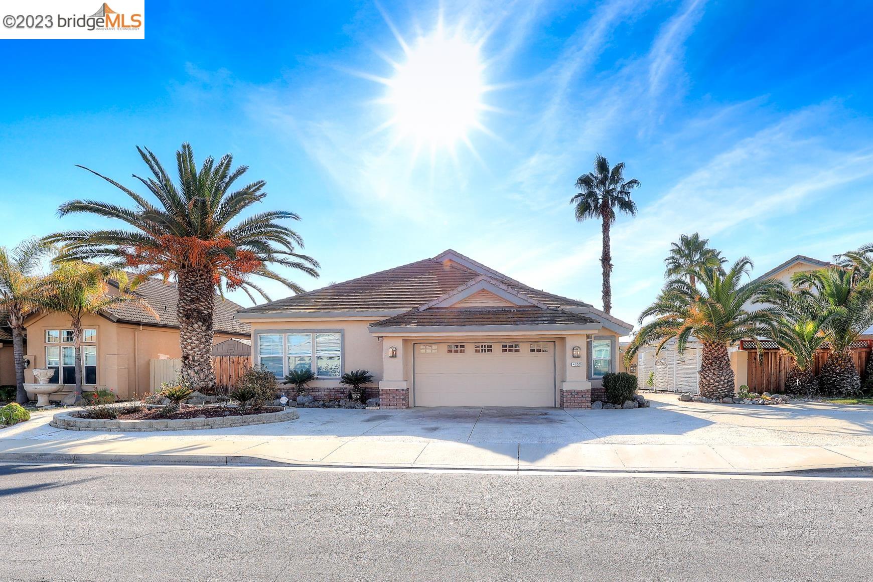 4050 Pier Point, Unit 100 Discovery Bay, CA 94505 - Photo 1 of 60 a front view of a house with a yard and garage