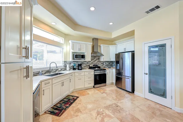 a living room with kitchen island furniture and large window
