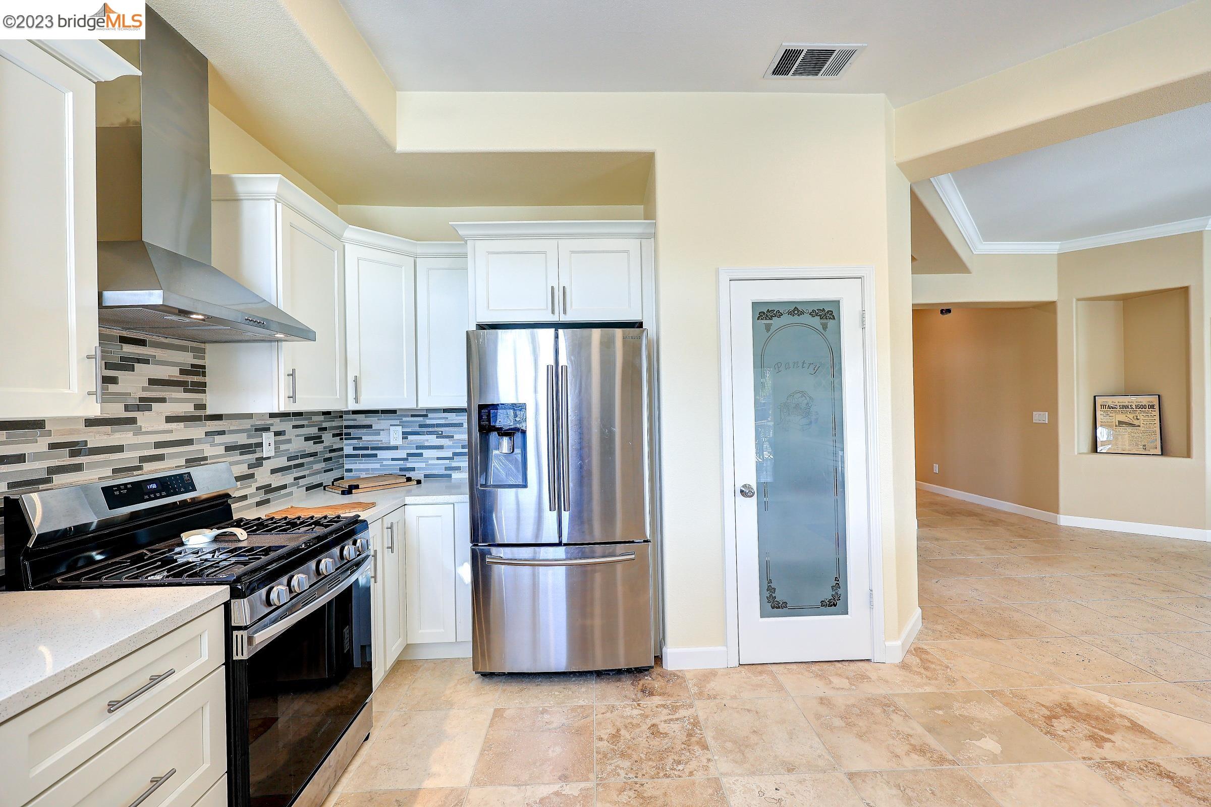 4050 Pier Point, Unit 100 Discovery Bay, CA 94505 - Photo 15 of 60 a kitchen with stainless steel appliances granite countertop a stove a refrigerator and a refrigerator