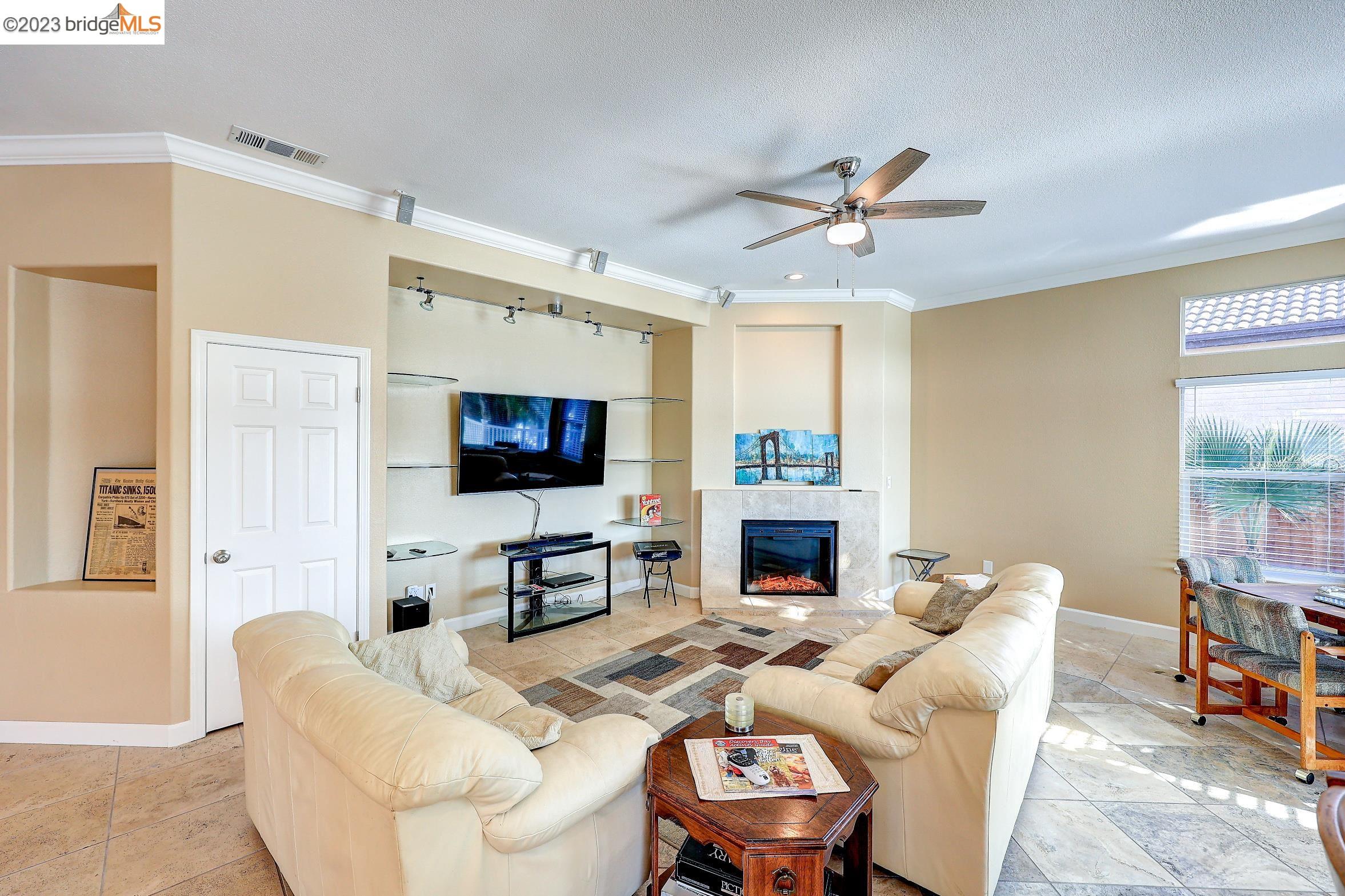4050 Pier Point, Unit 100 Discovery Bay, CA 94505 - Photo 18 of 60 a living room with furniture a fireplace and a flat screen tv