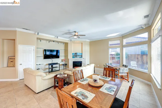 a living room with fireplace furniture and a flat screen tv