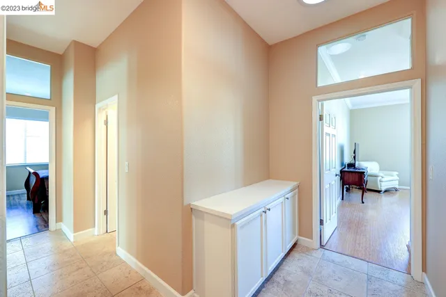 a bedroom with a bed a dresser and a chandelier