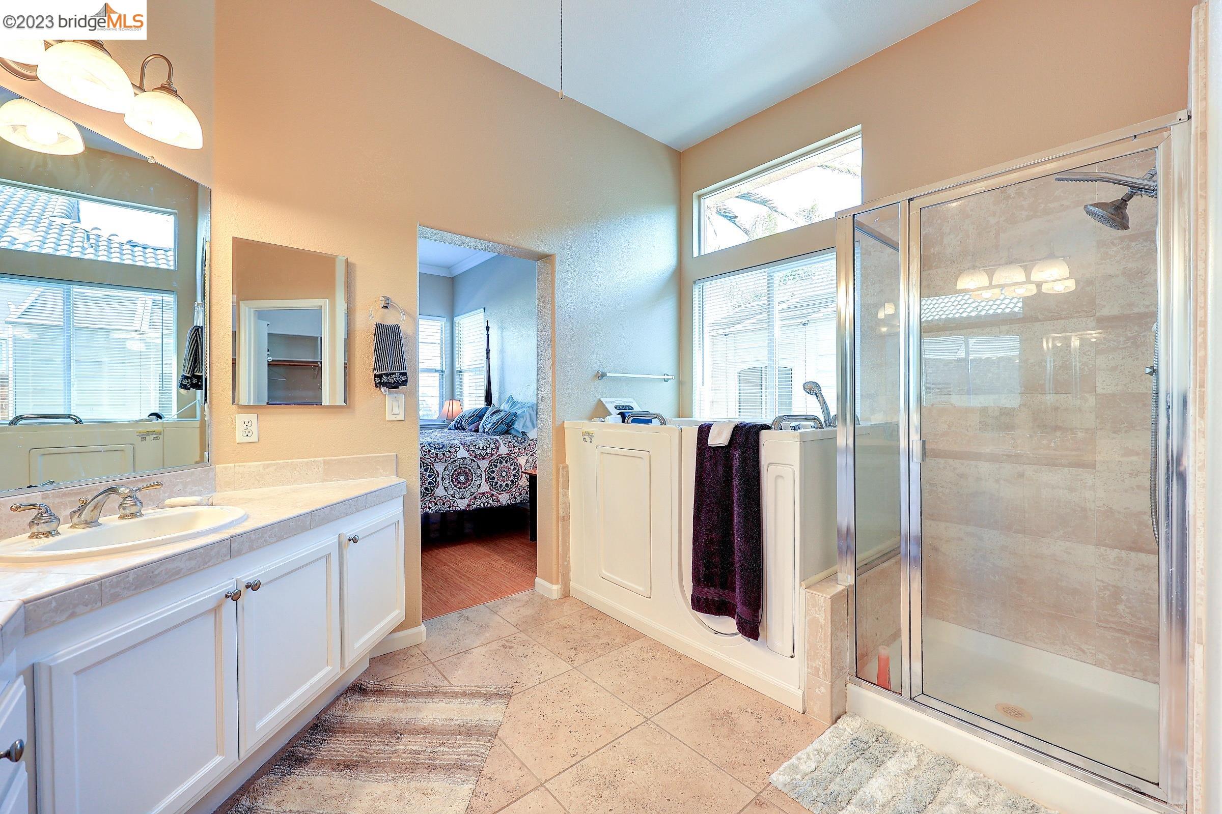4050 Pier Point, Unit 100 Discovery Bay, CA 94505 - Photo 28 of 60 a bathroom with a double vanity sink and a mirror