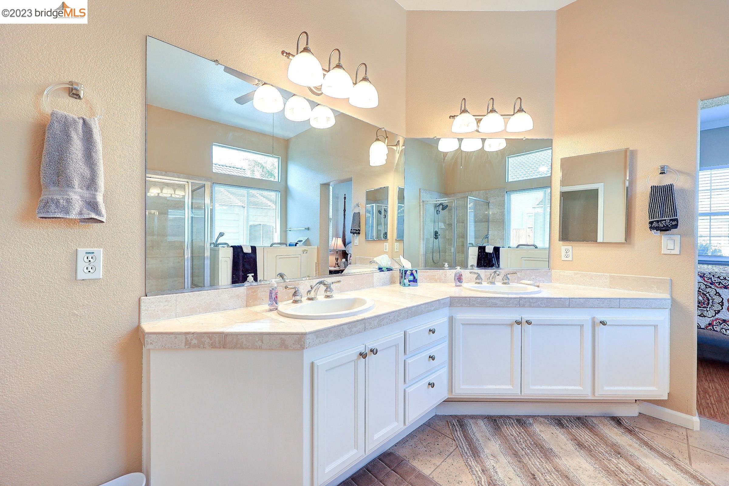 4050 Pier Point, Unit 100 Discovery Bay, CA 94505 - Photo 30 of 60 a bathroom with a sink vanity and a mirror