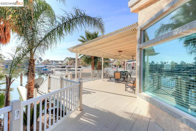a view of a patio with a dining table and chairs with wooden floor