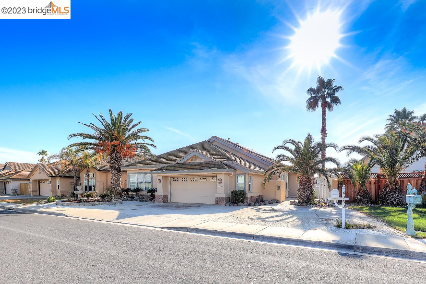 4050 Pier Point, Unit 100 Discovery Bay, CA 94505 - Photo 6 of 60 a view of a house with a yard and palm trees
