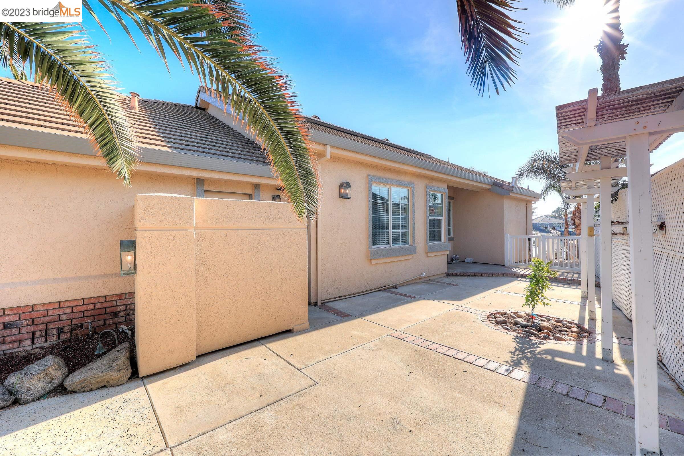 4050 Pier Point, Unit 100 Discovery Bay, CA 94505 - Photo 8 of 60 a front view of a house with a yard