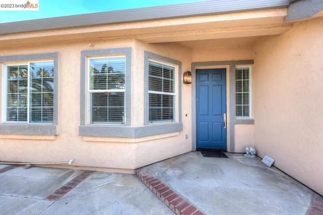 a view of a hallway with a livingroom and a bathroom