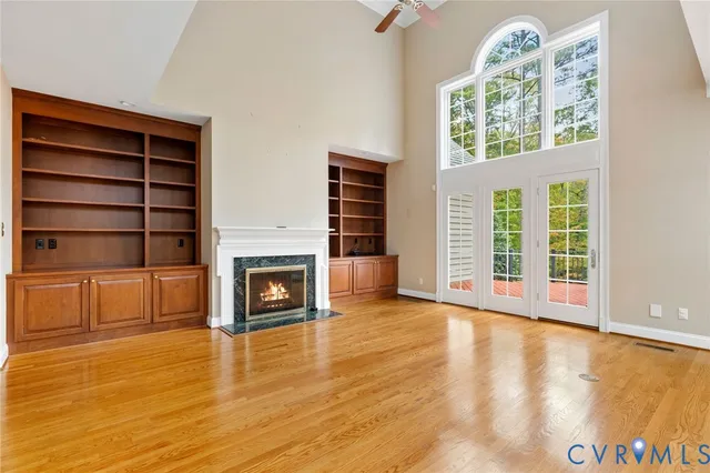 a view of an empty room with a fireplace and a window