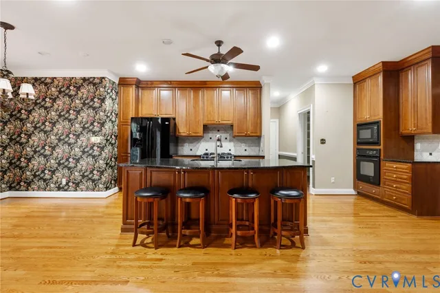 a kitchen with stainless steel appliances granite countertop a stove and a refrigerator