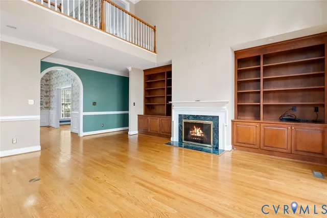a view of a livingroom with wooden floor and a fireplace