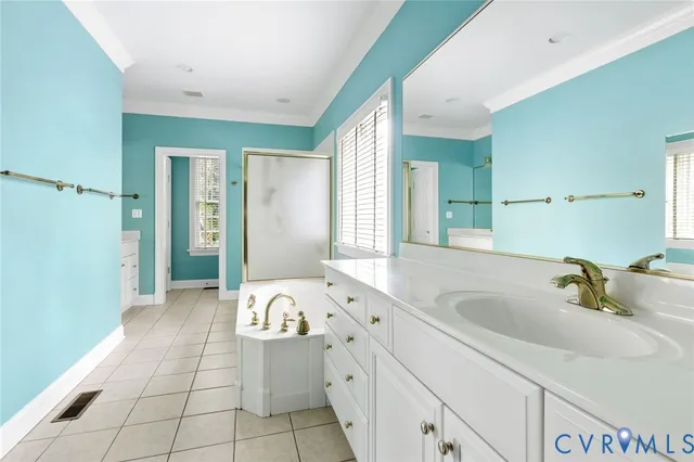 a spacious bathroom with a tub sink and mirror