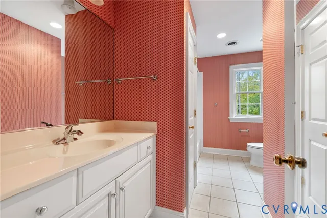 a bathroom with a sink a toilet and a shower