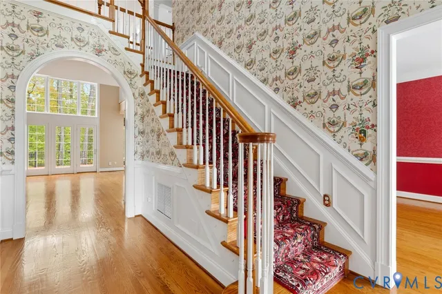 a view of entryway with wooden floor and windows